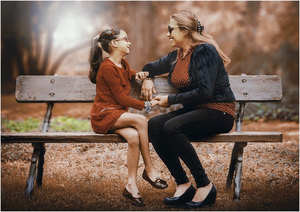 WOMAN AND GIRL ON A BENCH WOMENS DAY