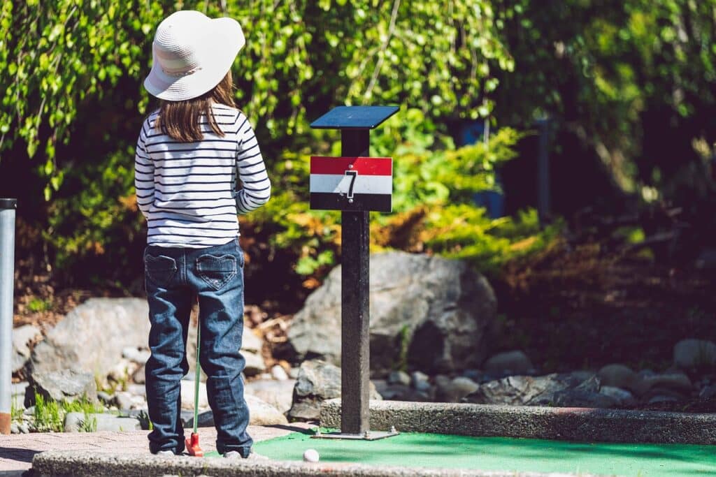 Life Needs Motion Child playing Mini Golf