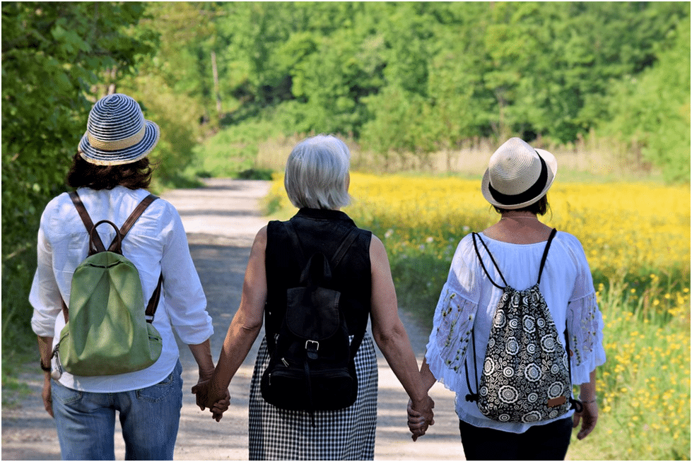 The Sisterhood Women Holding Hands While Strolling