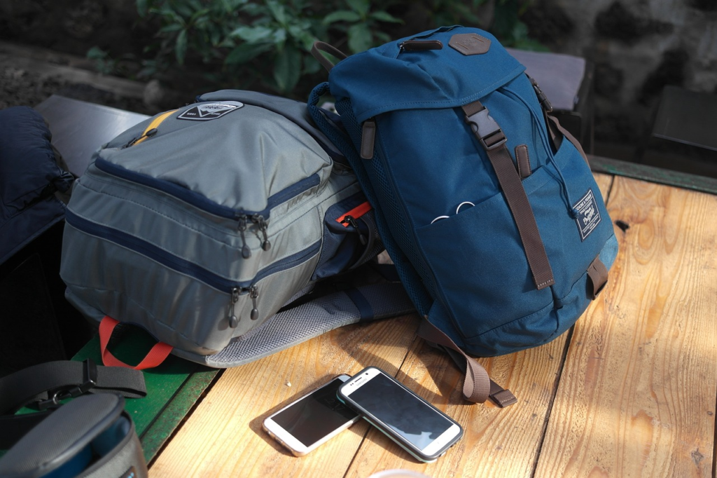 THE POPULAR BACKPACK BLUE AND GREY BACKPACKS ON A TABLE